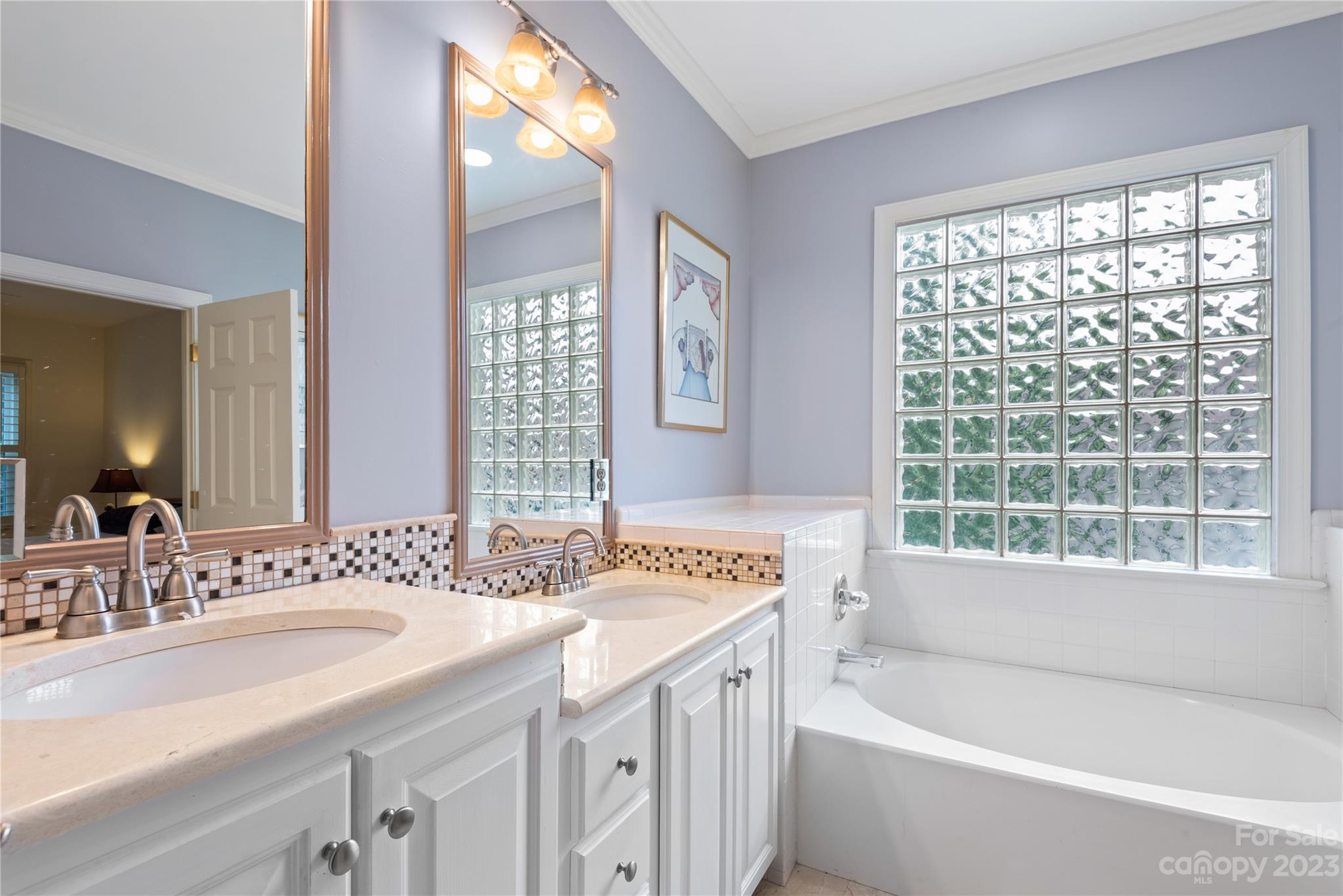 7604 Bosham Lane Charlotte, NC 28270 - Photo 23 of 39 a bathroom with a granite countertop sink and a bathtub