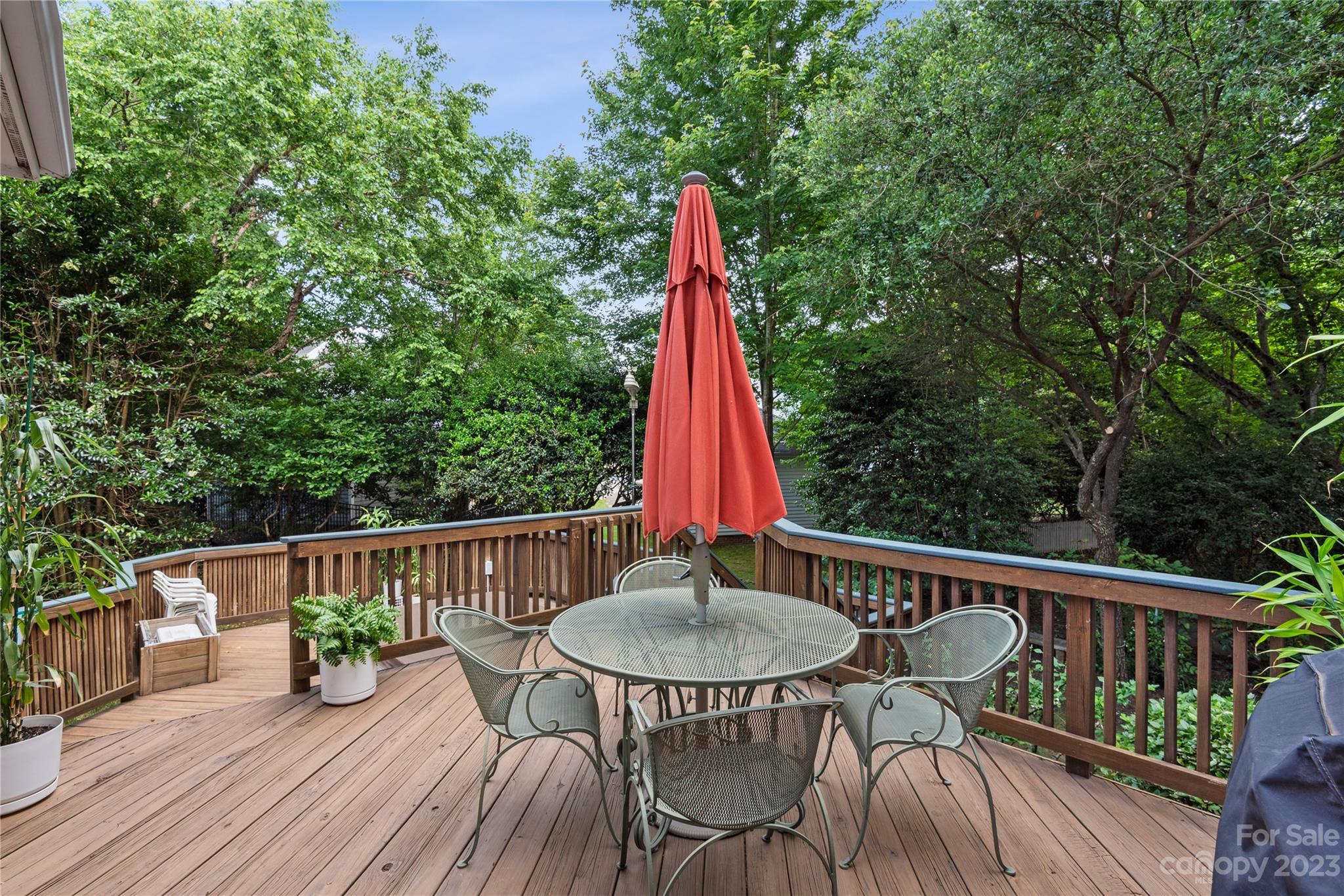 7604 Bosham Lane Charlotte, NC 28270 - Photo 31 of 39 a view of a deck with a table and chairs a barbeque with wooden floor and fence