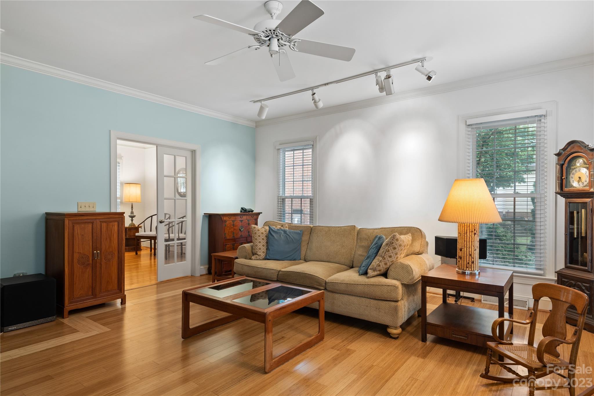 7604 Bosham Lane Charlotte, NC 28270 - Photo 10 of 39 a living room with furniture a wooden floor and a lamp