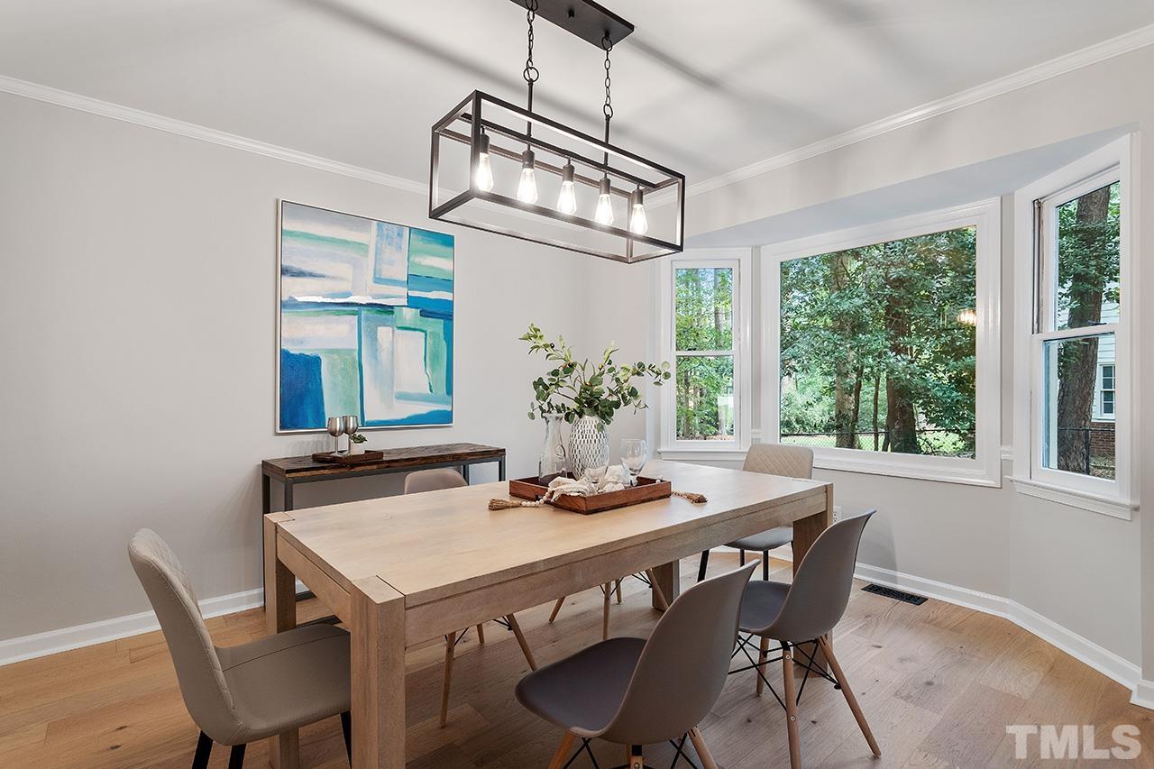 8805 Wellsley Way Raleigh, NC 27613 - Photo 14 of 39 a view of a dining room with furniture window and outside view
