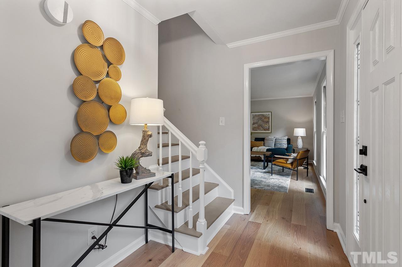 8805 Wellsley Way Raleigh, NC 27613 - Photo 16 of 39 a view of entryway and hall with wooden floor