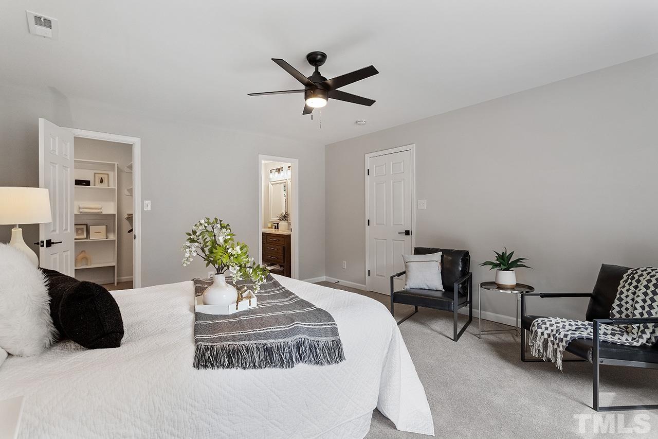 8805 Wellsley Way Raleigh, NC 27613 - Photo 18 of 39 a bedroom with a bed and ceiling fan