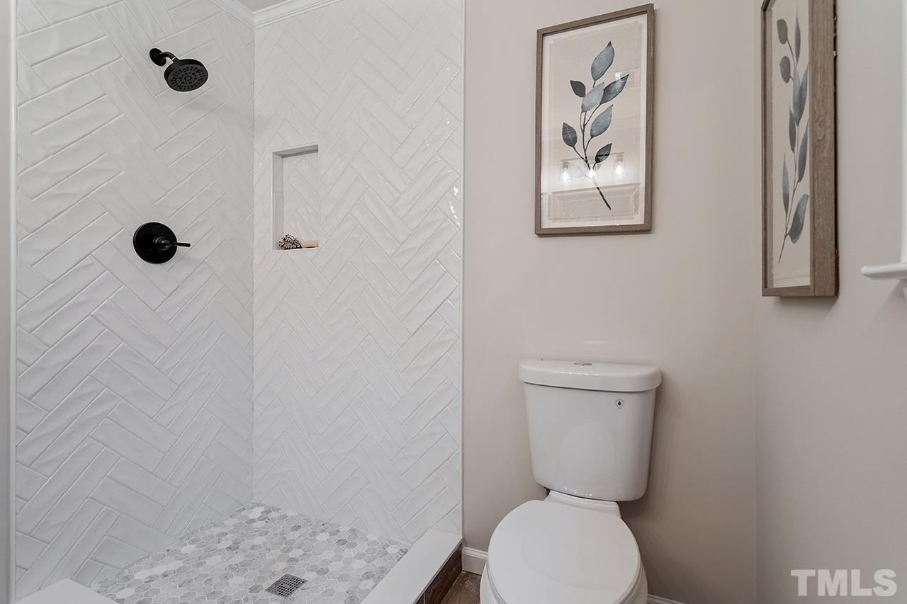 8805 Wellsley Way Raleigh, NC 27613 - Photo 20 of 39 a bathroom with a toilet and a shower