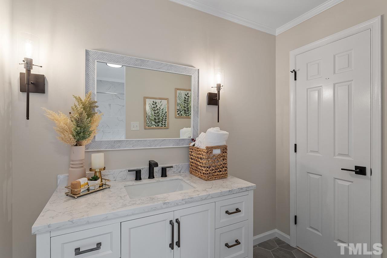 8805 Wellsley Way Raleigh, NC 27613 - Photo 25 of 39 a bathroom with a sink and a mirror
