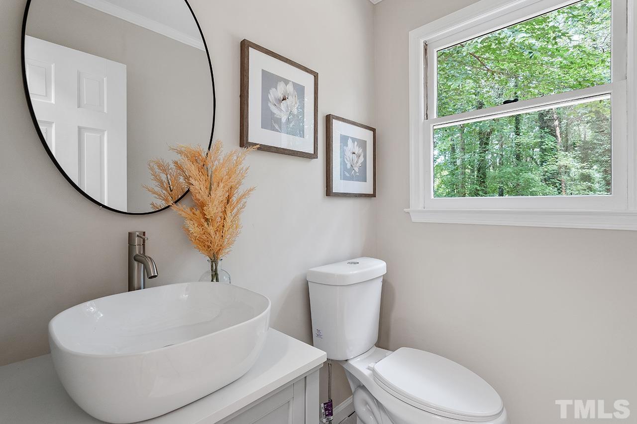 8805 Wellsley Way Raleigh, NC 27613 - Photo 27 of 39 a white toilet sitting next to a bathroom sink