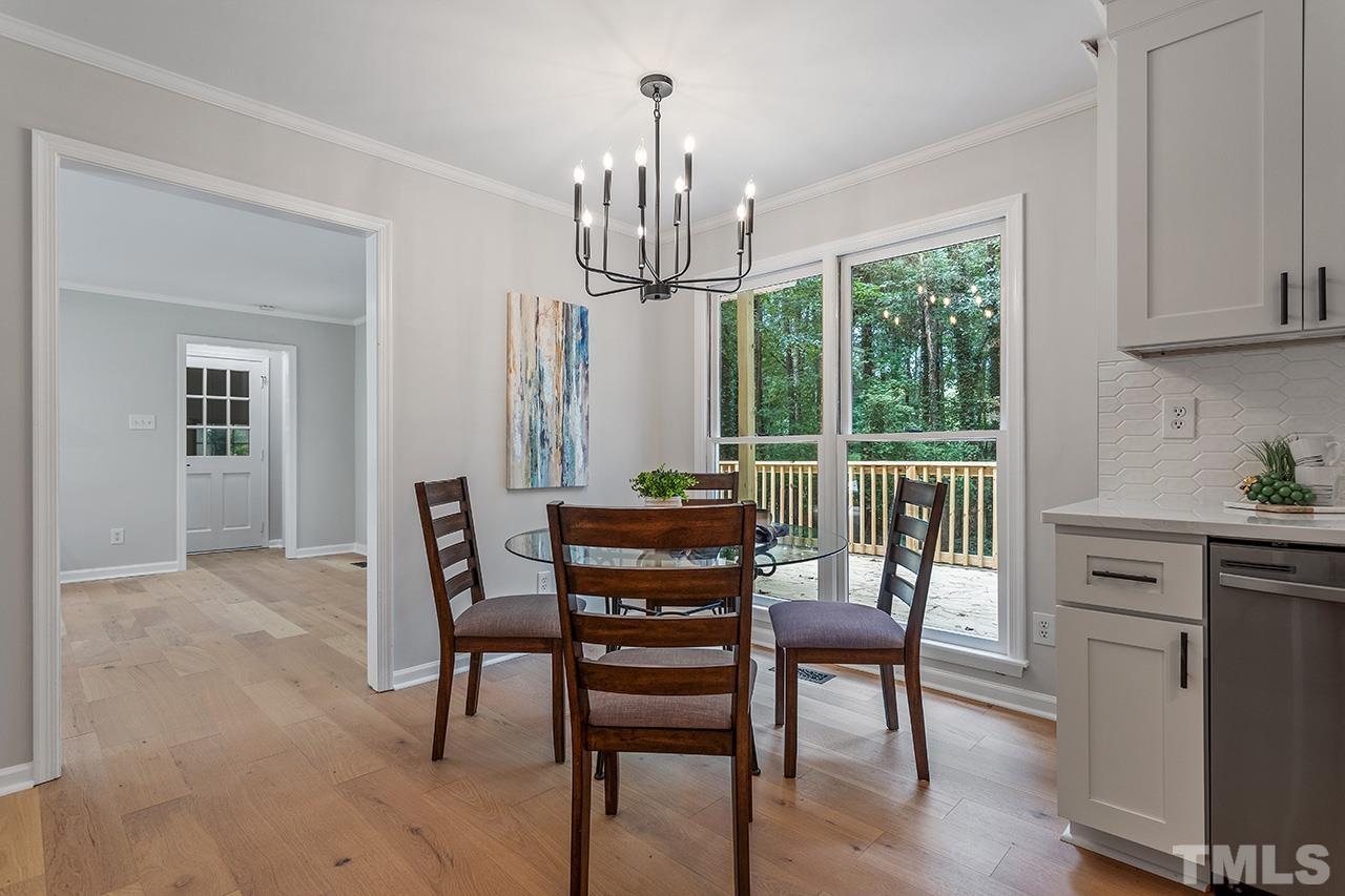 8805 Wellsley Way Raleigh, NC 27613 - Photo 8 of 39 a view of a dining room with furniture window and wooden floor