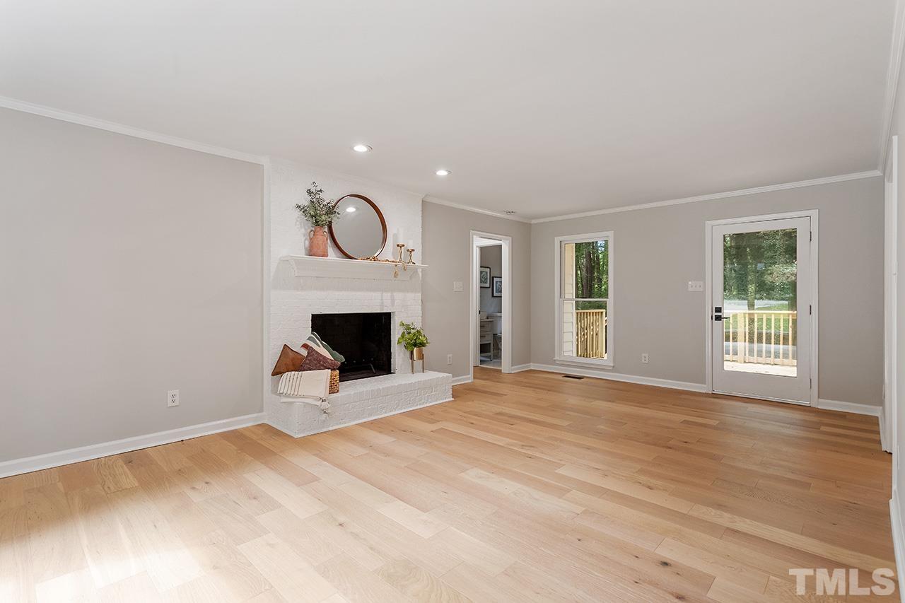 8805 Wellsley Way Raleigh, NC 27613 - Photo 10 of 39 a view of an empty room with a fireplace and a window
