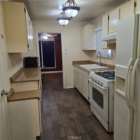 a kitchen with stainless steel appliances granite countertop a stove a refrigerator and a microwave
