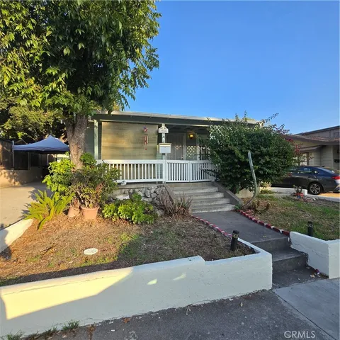 a view of a house with a yard and a garden