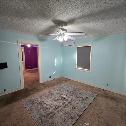 a view of a room with a ceiling fan and a window