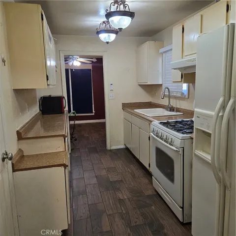 a kitchen with stainless steel appliances granite countertop a stove a refrigerator and a microwave