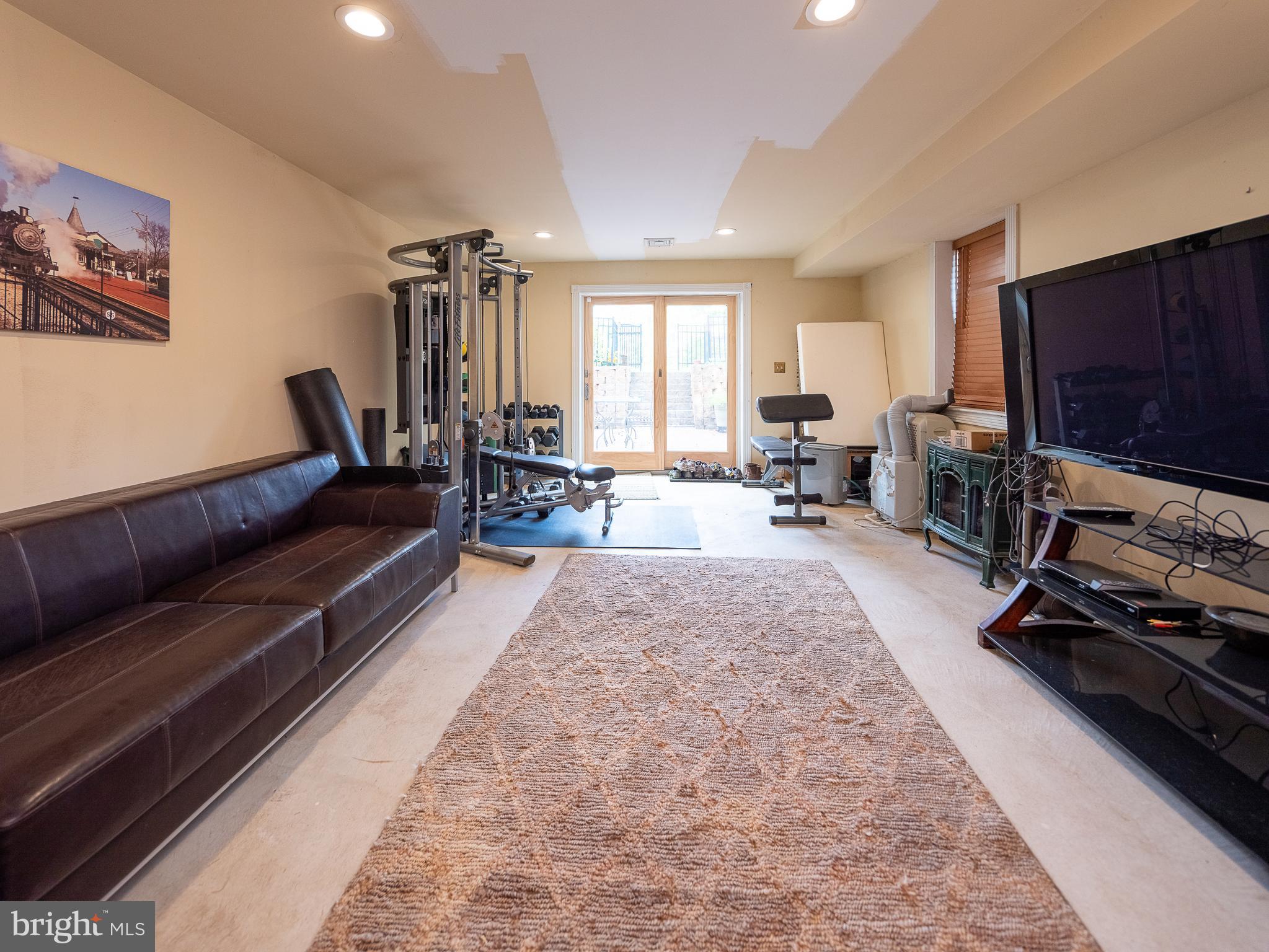 1601 Forest Grove Road Furlong, PA 18925 - Photo 34 of 57 a living room with furniture and a flat screen tv