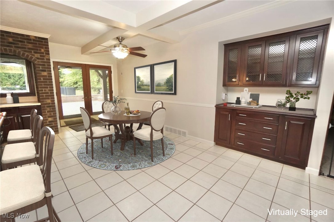 1760 Chartley Road Gates Mills, OH 44040 - Photo 9 of 49 Eat in kitchen space featuring beamed ceiling, light tile patterned floors, french doors, a ceiling fan, and coffered ceiling