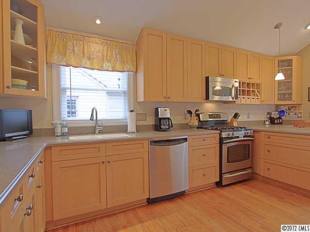 2012 Club Road Charlotte, NC 28205 - Photo 5 of 15 a kitchen with cabinets appliances a sink and a counter top space