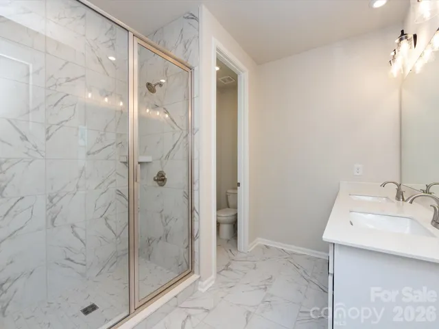 a bathroom with a shower and a sink