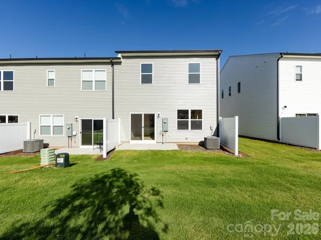 a view of a house with backyard and porch