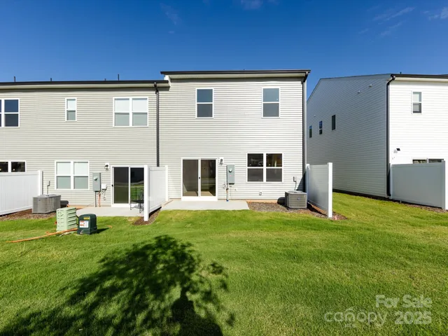 a view of a house with backyard and porch