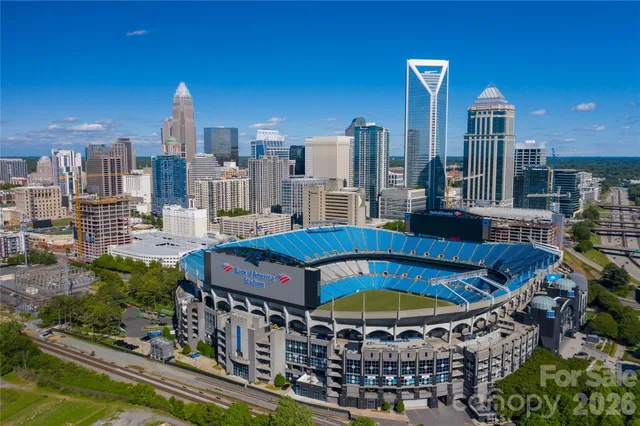 a blue swimming pool with outdoor seating and yard