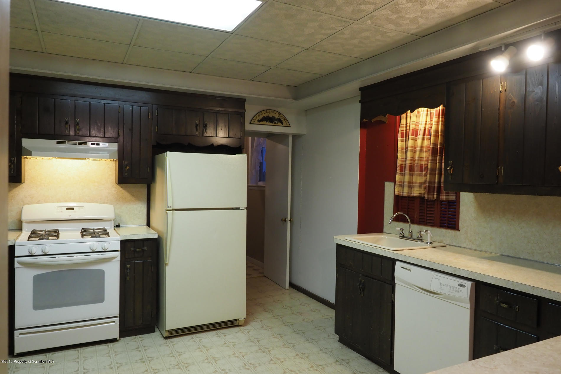 824 Green Ridge Street Scranton, PA 18509 - Photo 6 of 17 a kitchen with a refrigerator sink and stove