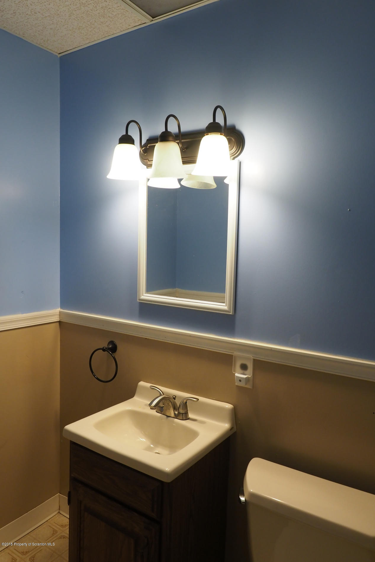 824 Green Ridge Street Scranton, PA 18509 - Photo 8 of 17 a bathroom with a sink and a mirror