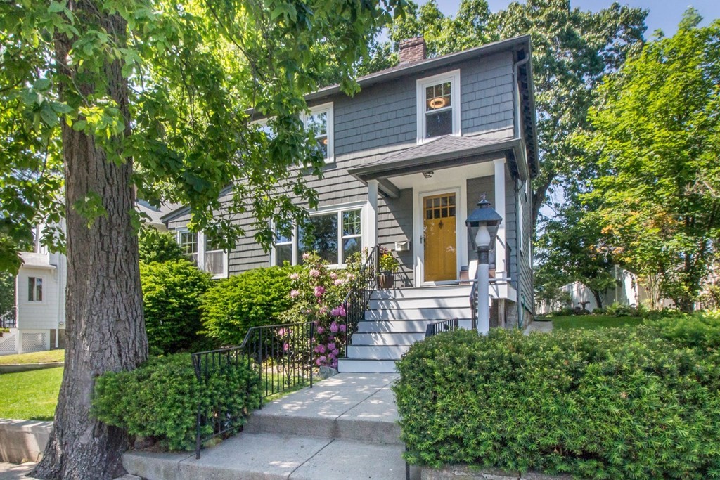 a front view of a house with garden