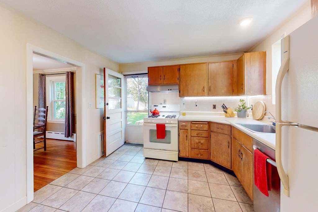 29 Hutchins Road Medford, MA 02155 - Photo 17 of 34 a kitchen with stainless steel appliances granite countertop a refrigerator and a stove top oven