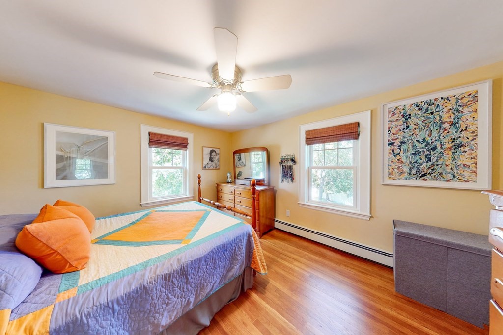 29 Hutchins Road Medford, MA 02155 - Photo 19 of 34 a bedroom with a bed and wooden floor
