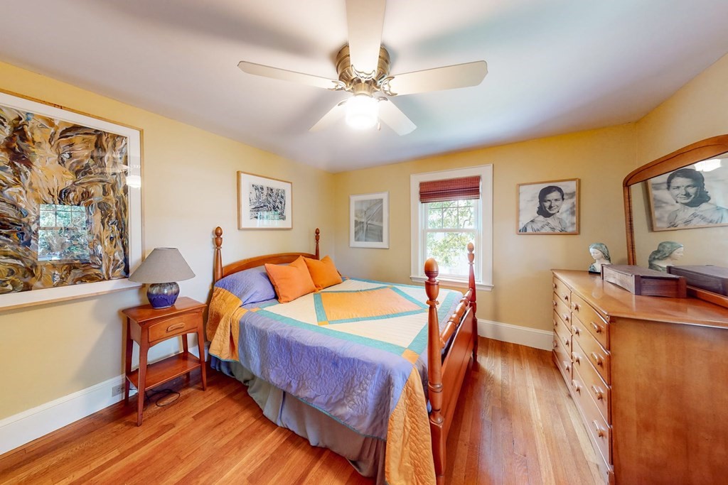 29 Hutchins Road Medford, MA 02155 - Photo 20 of 34 a bedroom with a bed and wooden floor