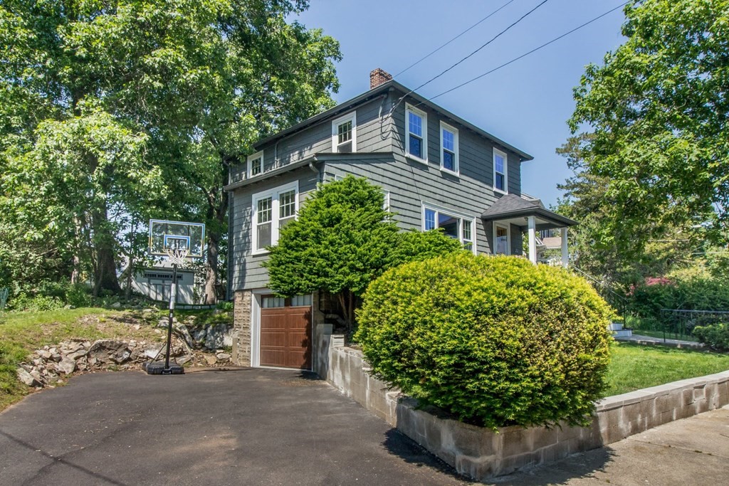 29 Hutchins Road Medford, MA 02155 - Photo 2 of 34 a front view of a house with a garden
