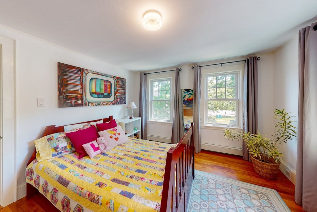 29 Hutchins Road Medford, MA 02155 - Photo 24 of 34 a bedroom with a bed and a potted plant