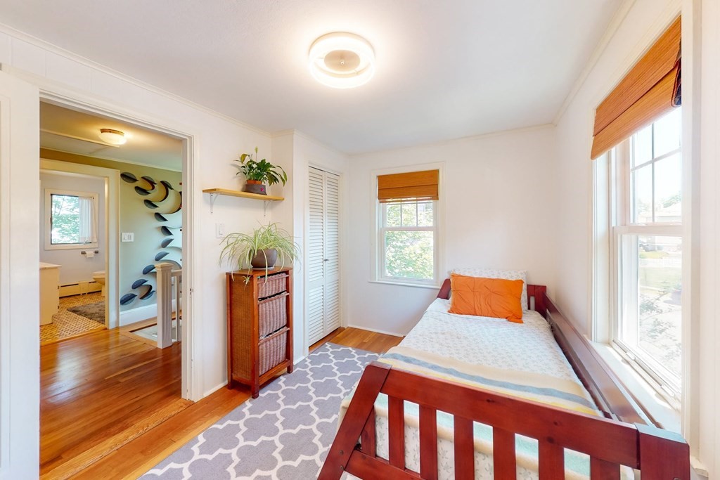 29 Hutchins Road Medford, MA 02155 - Photo 26 of 34 a bedroom with a bed and wooden floor
