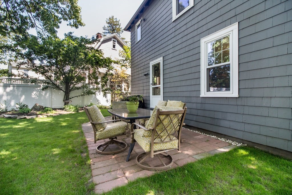 29 Hutchins Road Medford, MA 02155 - Photo 31 of 34 a view of a backyard with table and chairs and potted plants and large tree