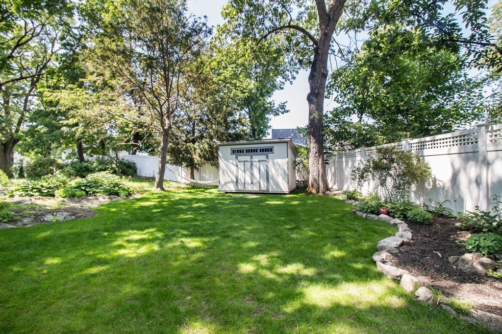 29 Hutchins Road Medford, MA 02155 - Photo 33 of 34 a view of backyard with table and chairs and a large tree