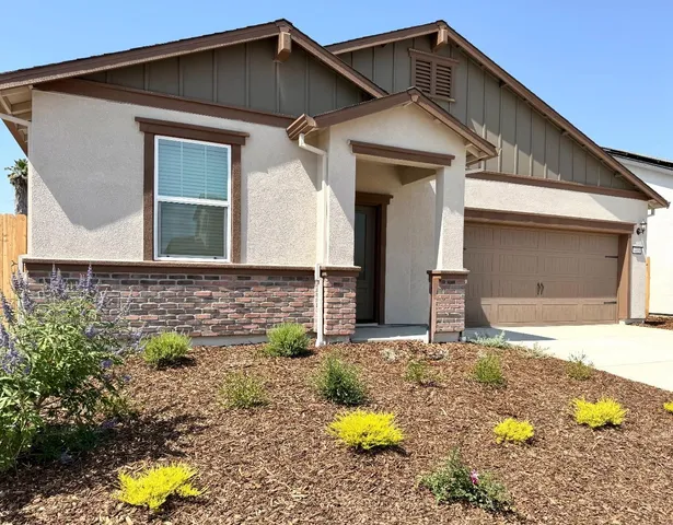a front view of a house with yard