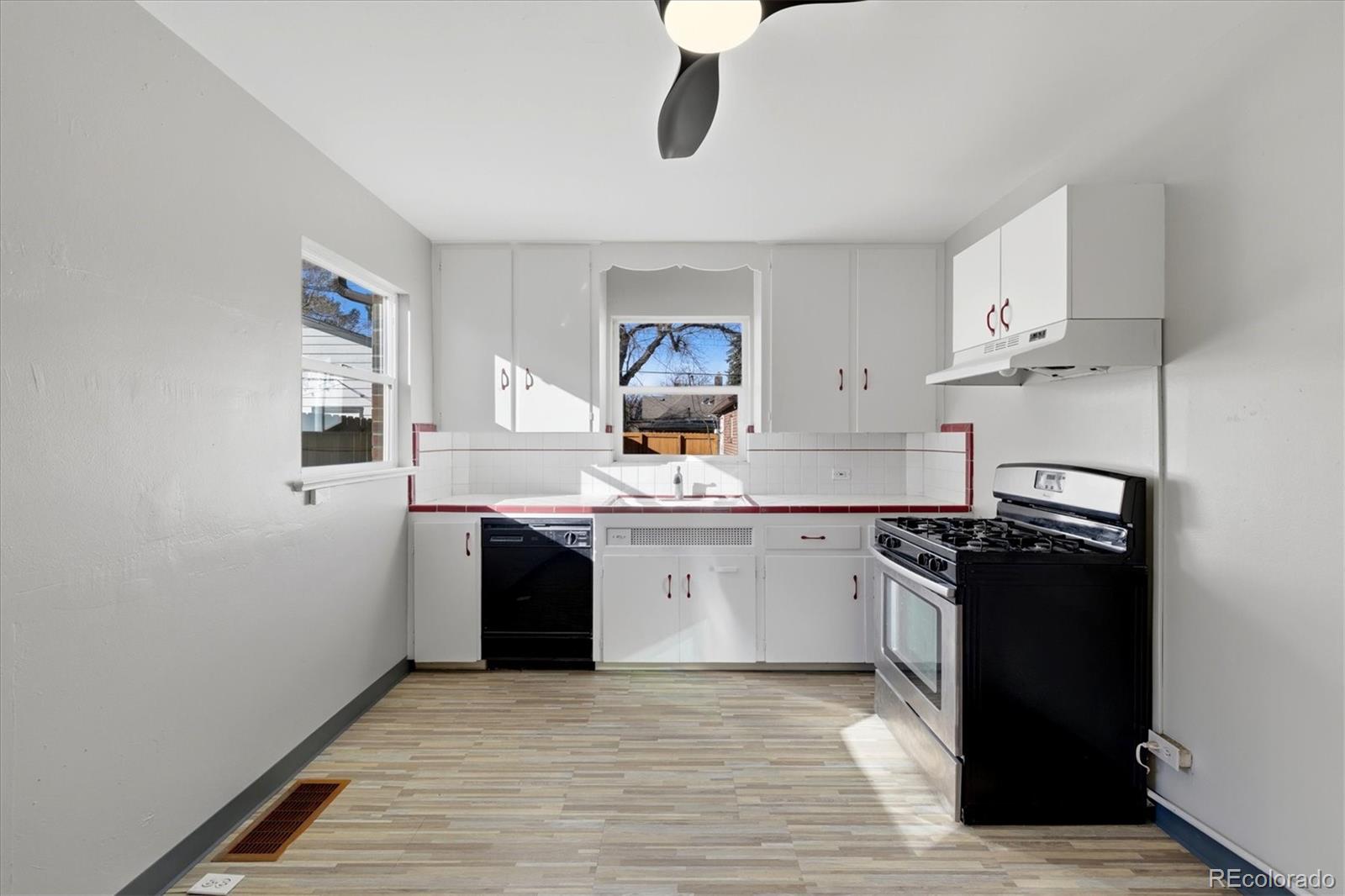 2053 Quitman Street Denver, CO 80212 - Photo 11 of 39 a kitchen with granite countertop a refrigerator stove and sink