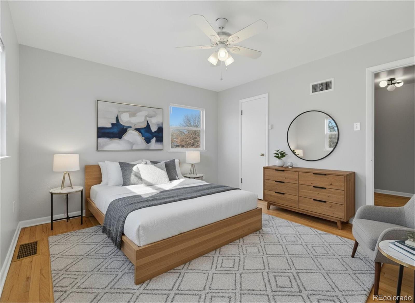 2053 Quitman Street Denver, CO 80212 - Photo 16 of 39 a bedroom with a bed a mirror on dresser and a window