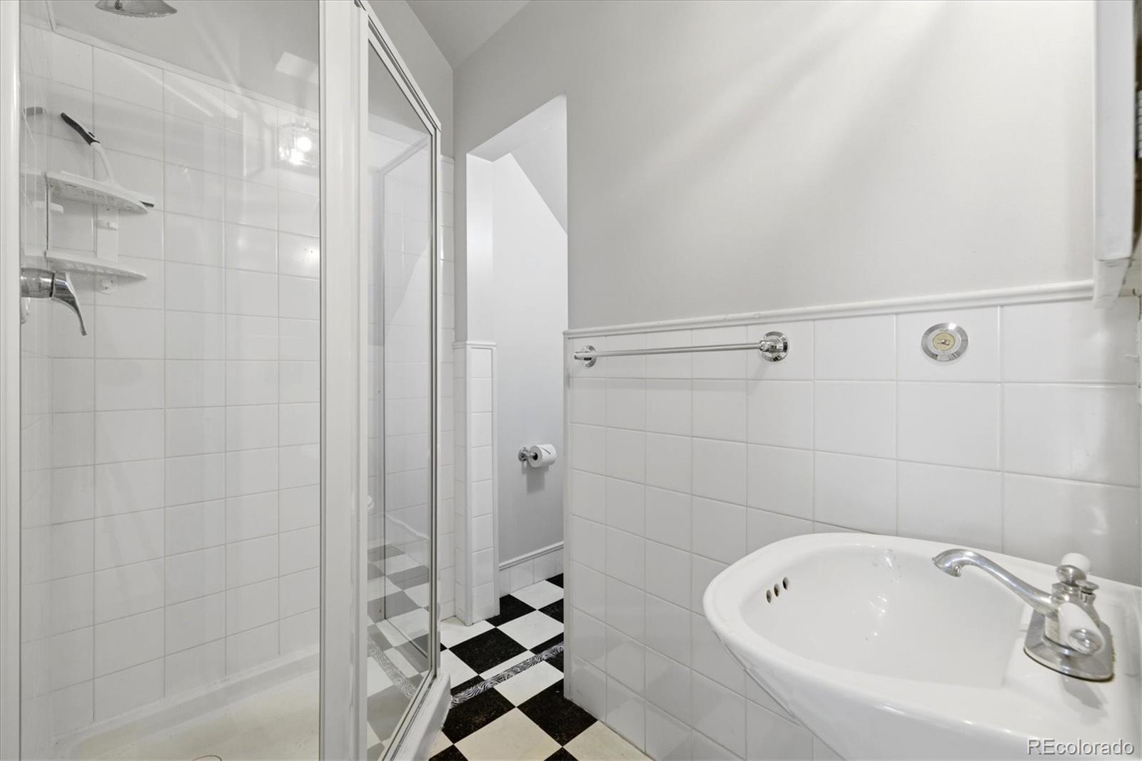 2053 Quitman Street Denver, CO 80212 - Photo 19 of 39 a bathroom with a bathtub and shower