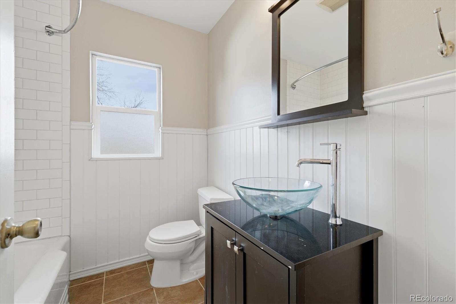 2053 Quitman Street Denver, CO 80212 - Photo 21 of 39 a bathroom with a granite countertop sink and a toilet