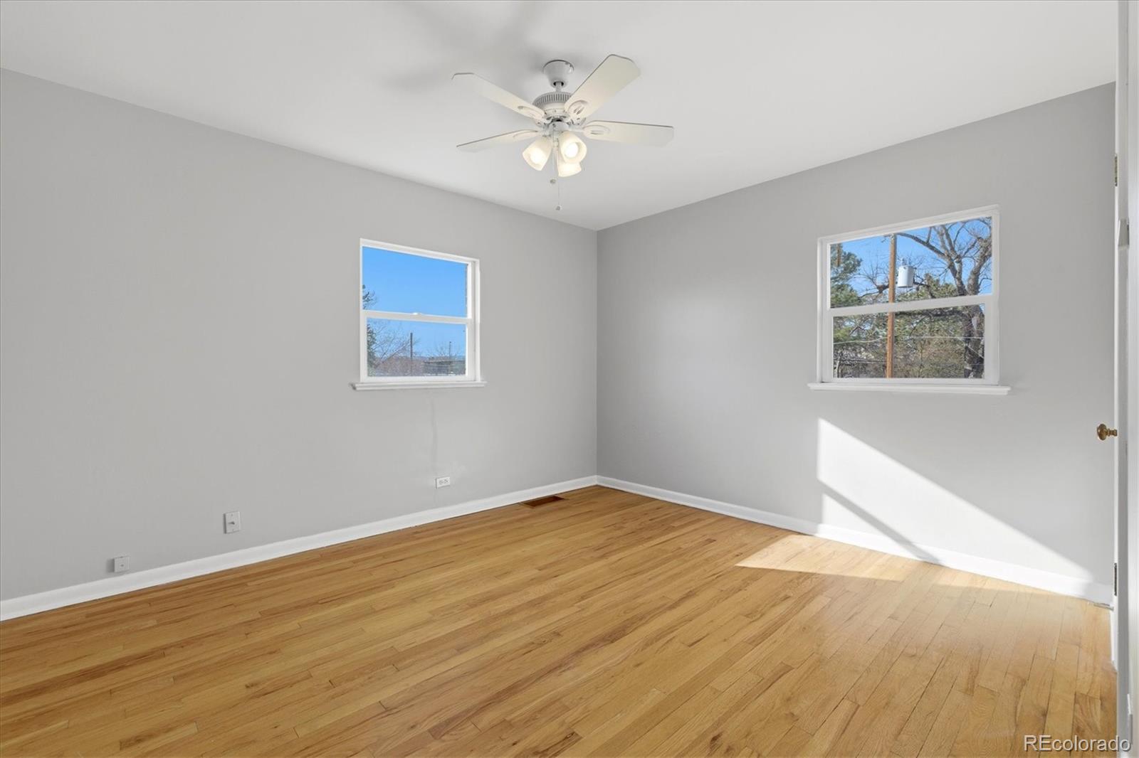 2053 Quitman Street Denver, CO 80212 - Photo 24 of 39 a view of an empty room with a window and a ceiling fan