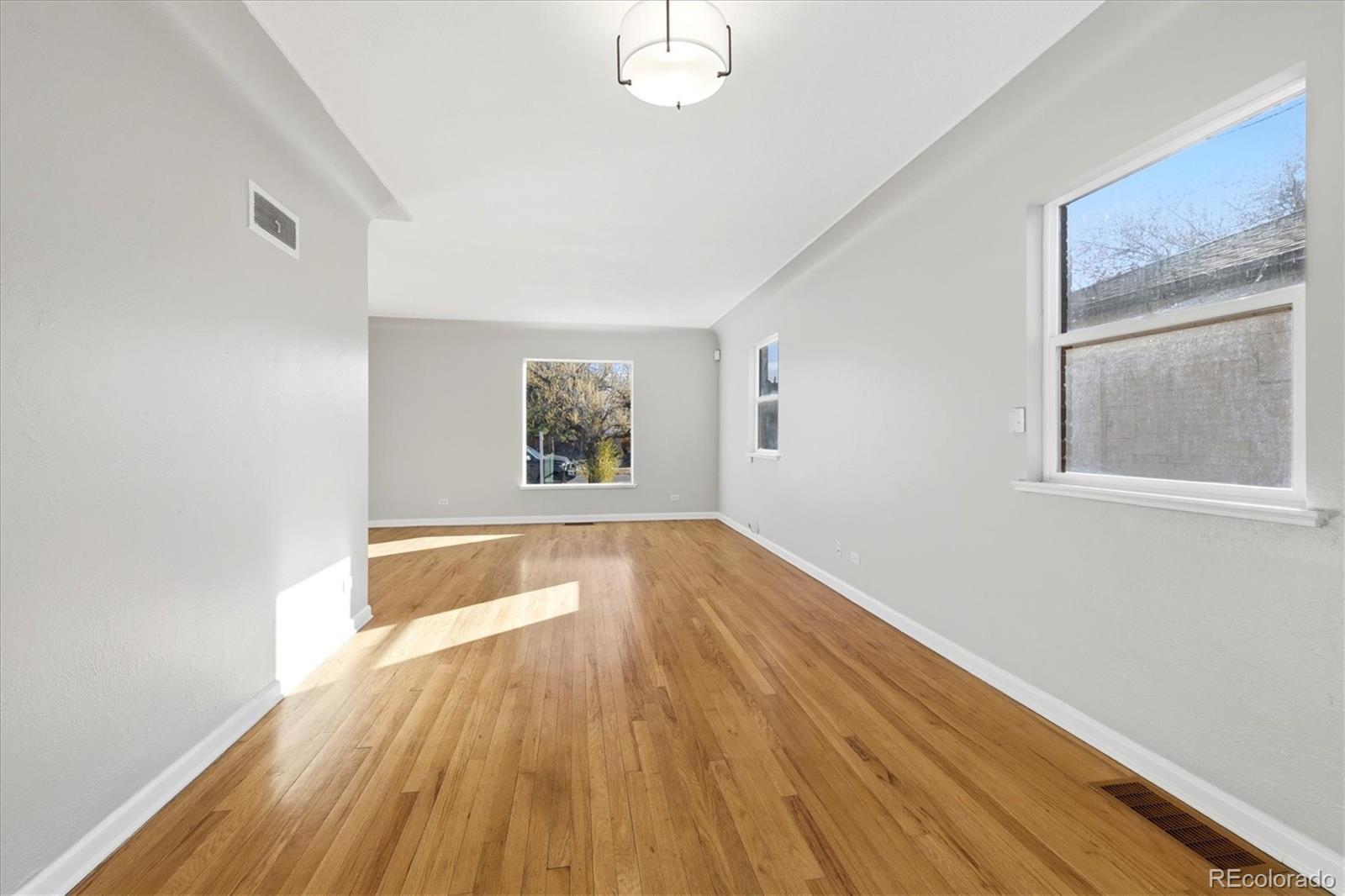 2053 Quitman Street Denver, CO 80212 - Photo 28 of 39 a view of an empty room with wooden floor and a window