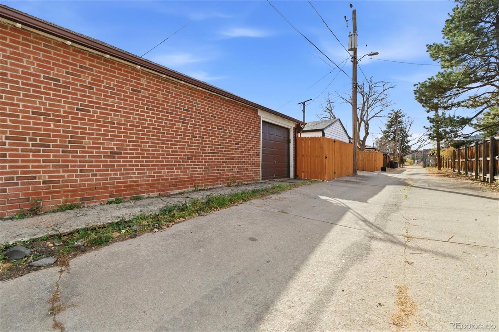 2053 Quitman Street Denver, CO 80212 - Photo 34 of 39 a front view of a house with a yard and garage