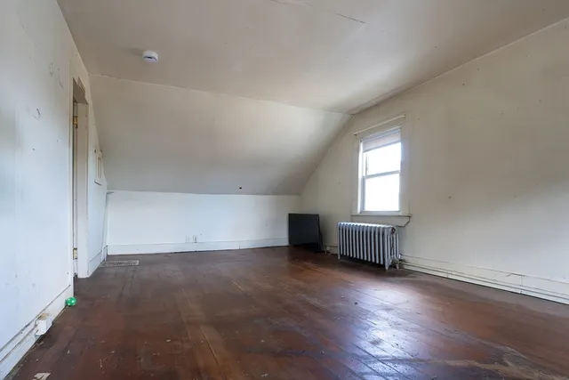a bedroom with a bed and flat screen tv
