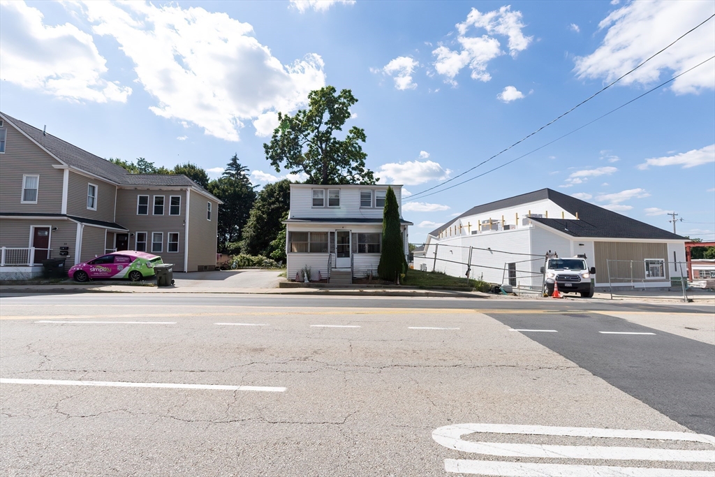 8 Thompson Road Webster, MA 01570 - Photo 23 of 24 a front view of a building with lot of cars and trees