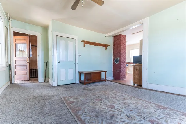 an empty room with windows and flowerpot