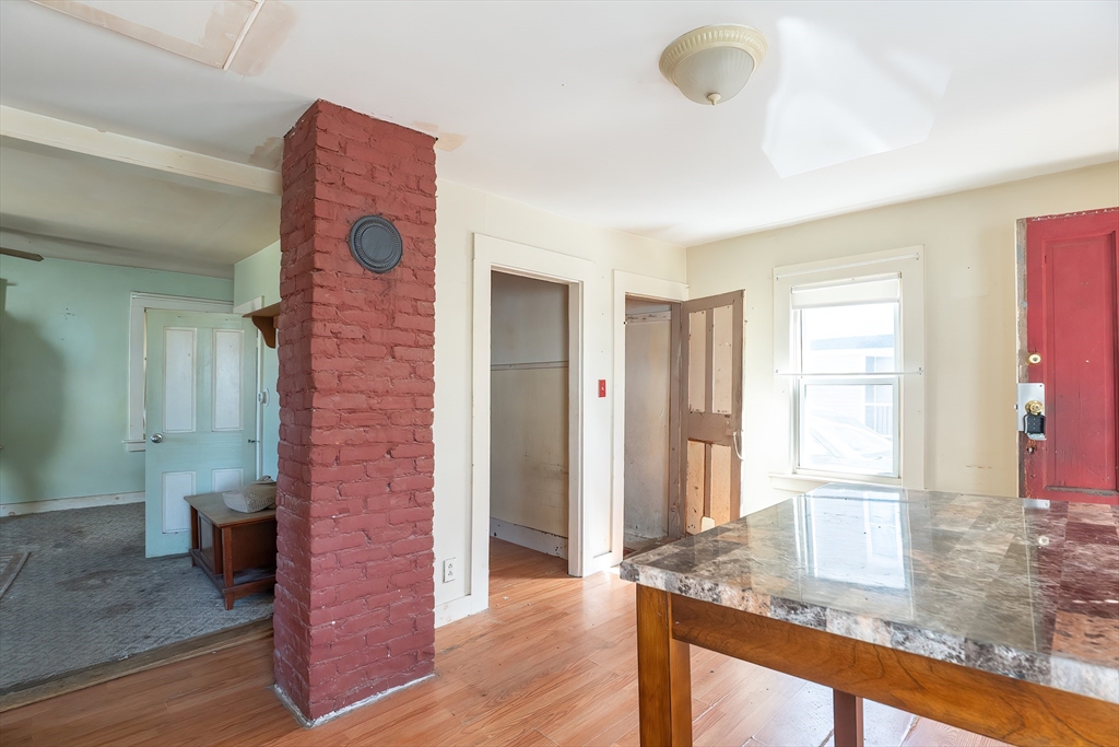 8 Thompson Road Webster, MA 01570 - Photo 6 of 24 a view of a hallway with wooden floor and staircase