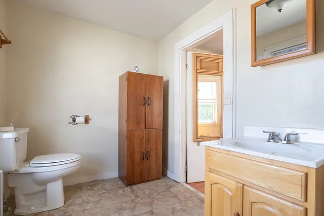 a bathroom with a toilet sink and a mirror