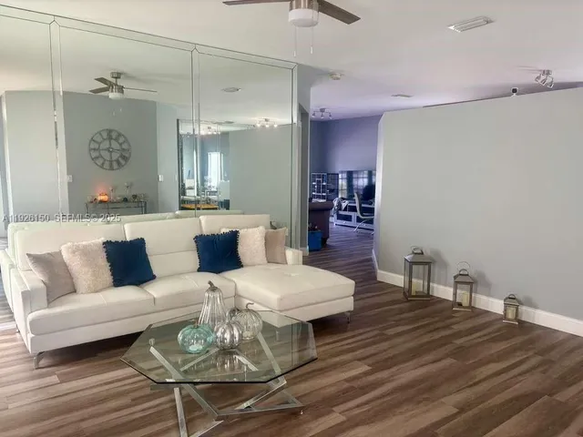 a living room with furniture and a wooden floor
