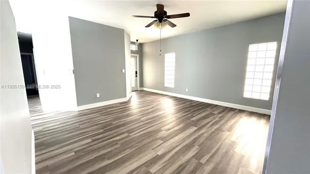 wooden floor in an empty room with a window