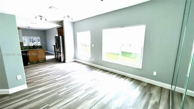 a kitchen with stainless steel appliances granite countertop a refrigerator and a stove top oven