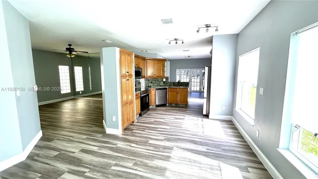 a kitchen with stainless steel appliances granite countertop a refrigerator stove and sink